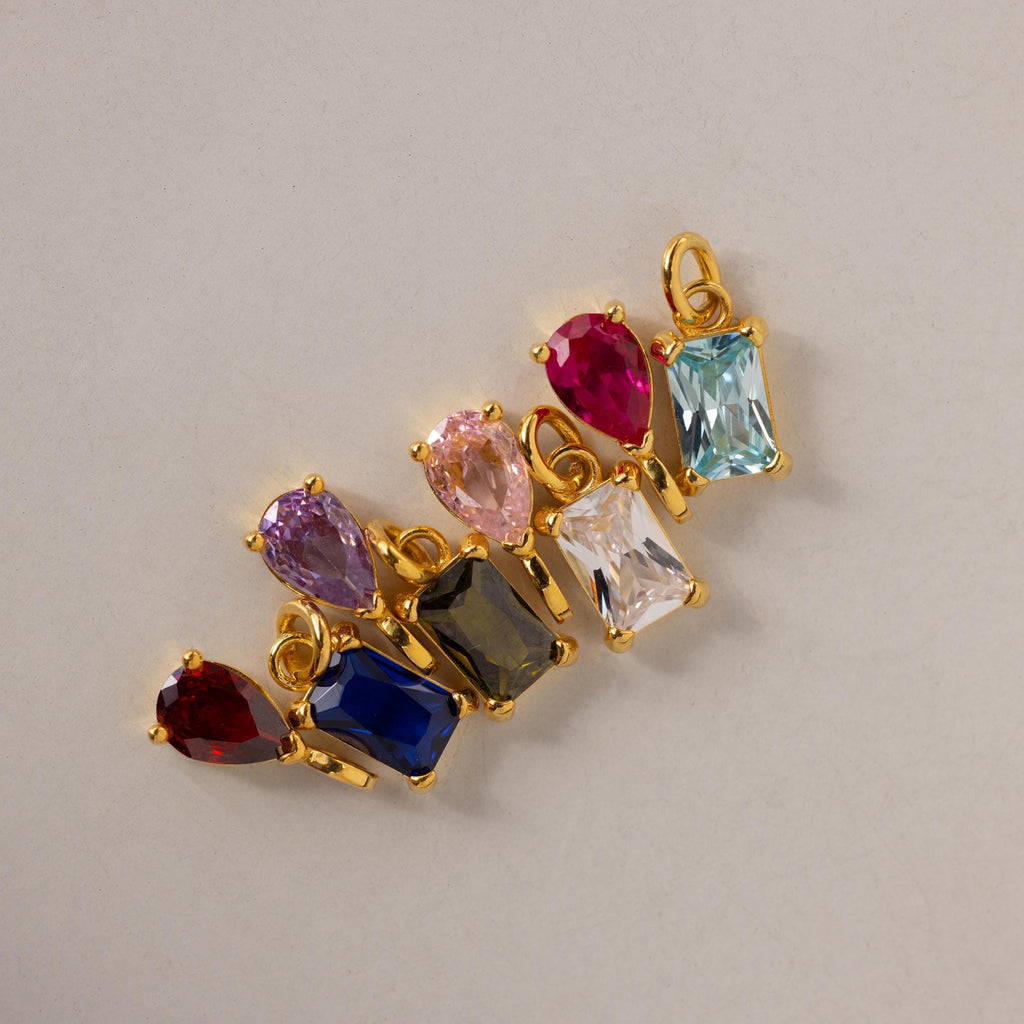 Multiple Pear & Baguette Birthstone Charms in different stone colors arranged side by side