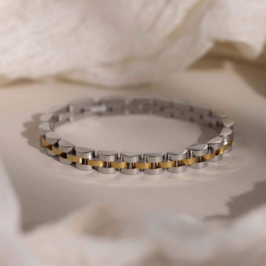 The Mixed Metal Link Bracelet in silver and gold is displayed on a soft, neutral background—an elegant and timeless gift for him.