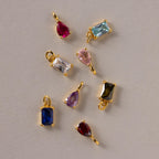 An assortment of Pear & Baguette Birthstone Charms in different stone colors
