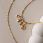 Gold Singapore twist necklace with an assortment of different styled birthstone charms