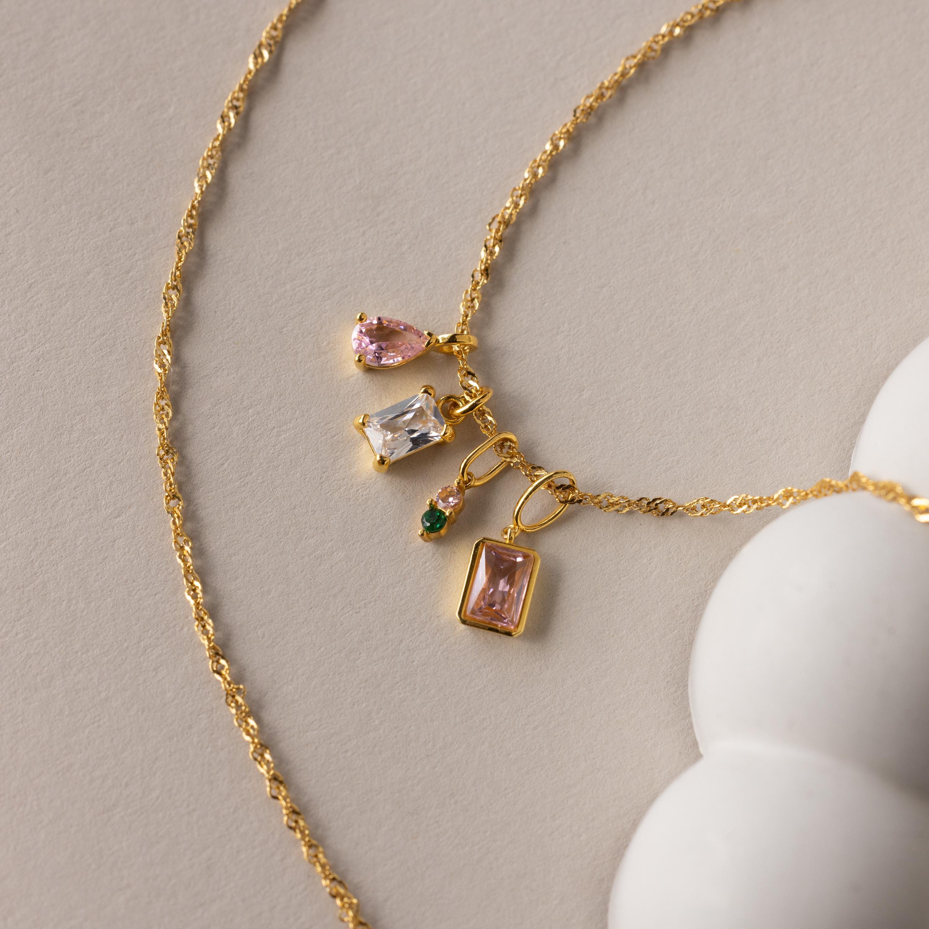 Gold Singapore twist necklace with an assortment of different styled birthstone charms