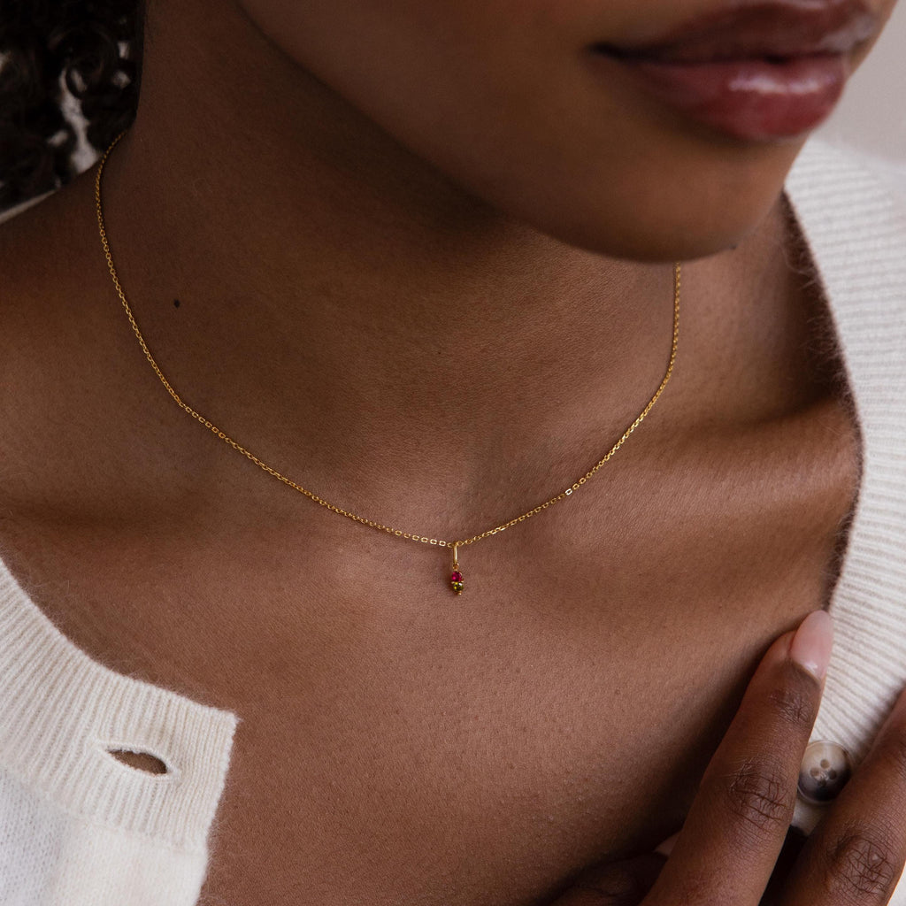 Model wears a gold Dainty Duo Birthstone Charm on a cable chain necklace