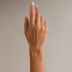 A hand displays four Dainty Pave Letter Necklaces in 18K Gold, each featuring a sparkling CZ diamond letter charm—A, B, C, and R—on delicate mirror chains.