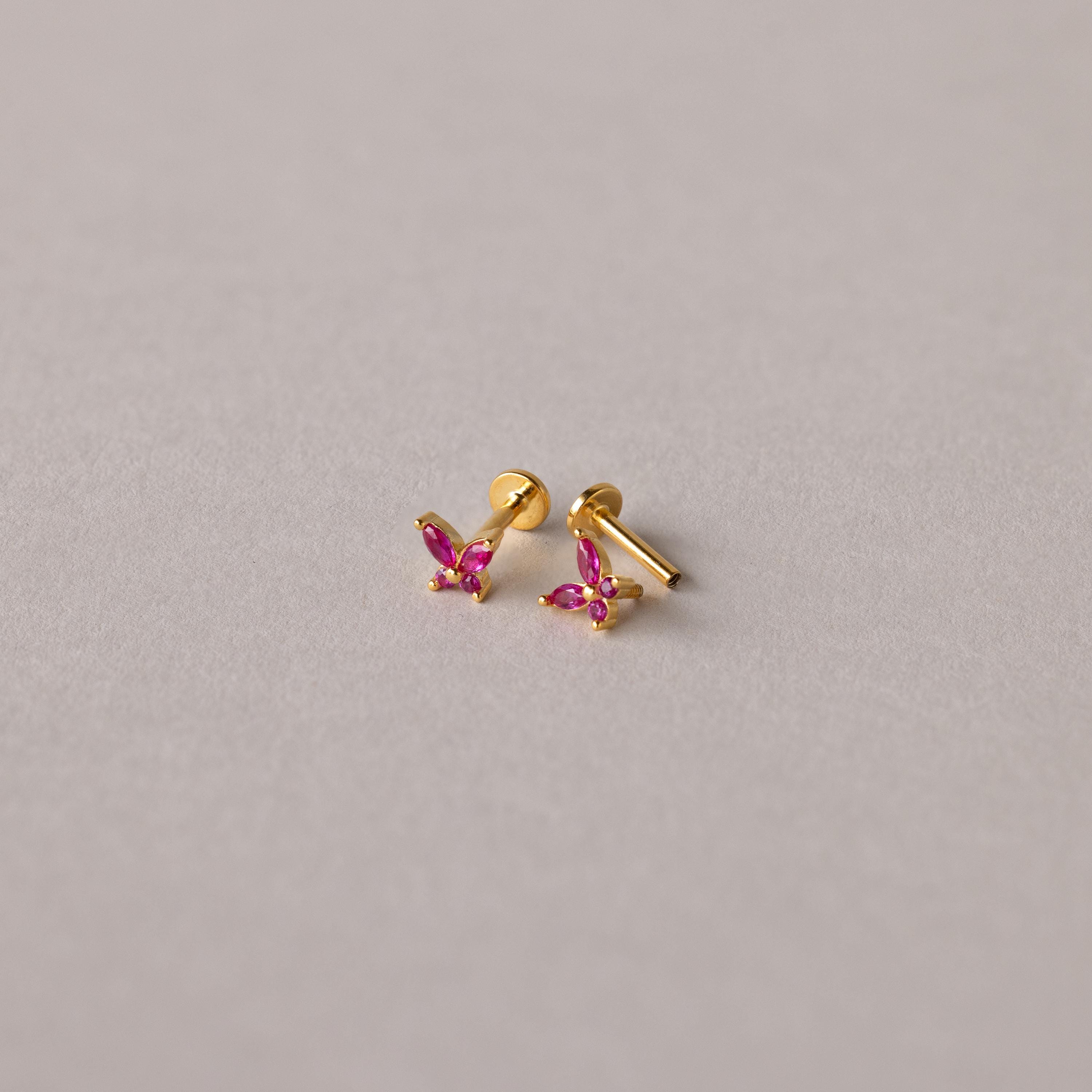The Butterfly Birthstone Flatback Studs are personalized gold earrings that add a unique touch to any look.