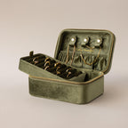 The Rectangle Velvet Jewelry Box in olive green displays rings, earrings, and bracelets neatly inside, adding a touch of sophistication and elegance to your jewelry collection.