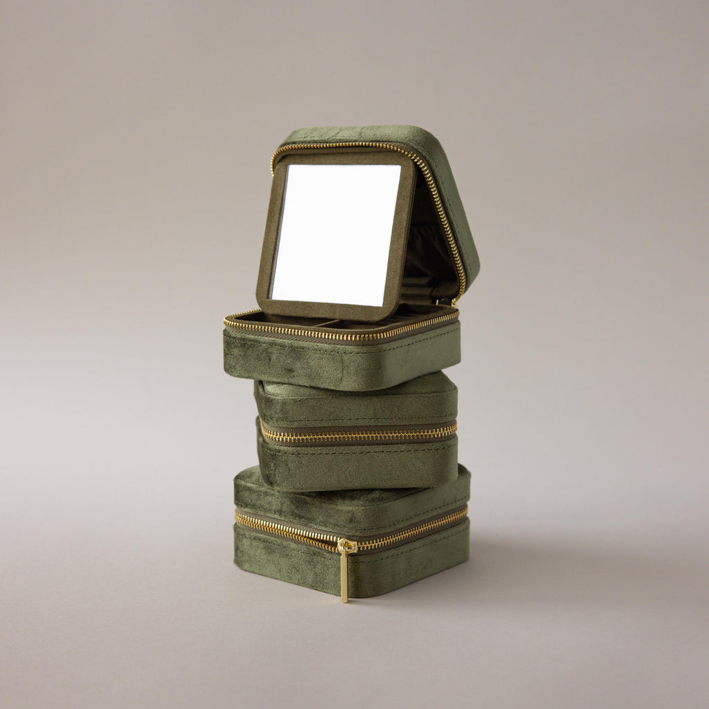 Three Velvet Mirror Jewelry Boxes in green are stacked, with the top box open to reveal a mirror inside its lid.