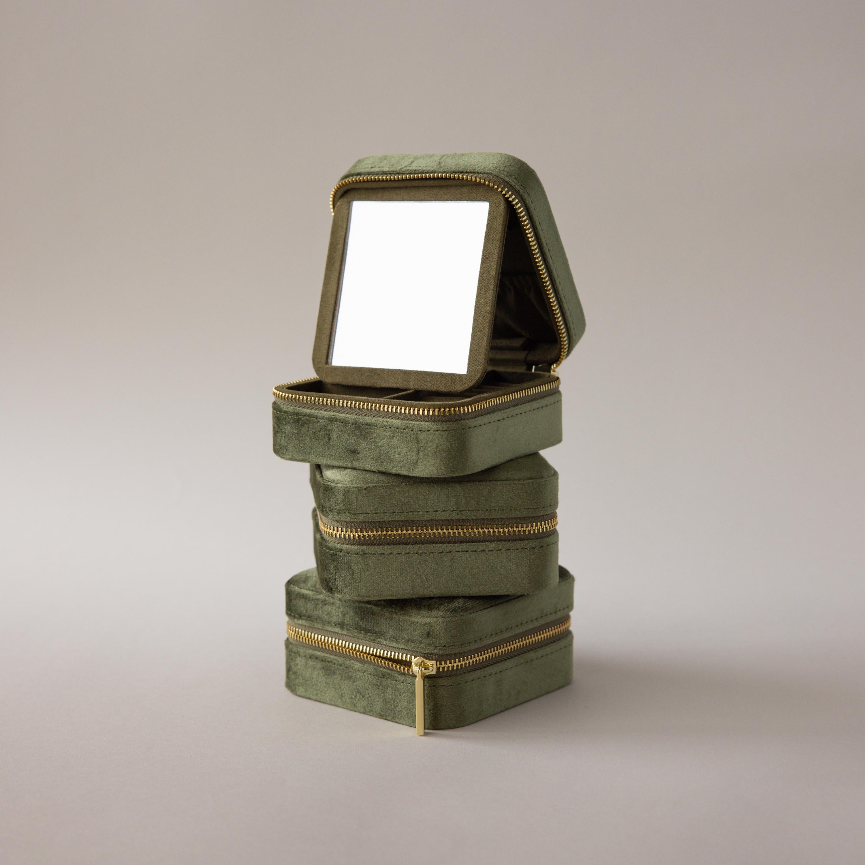 Three Velvet Mirror Jewelry Boxes in green are stacked, with the top box open to reveal a mirror inside its lid.