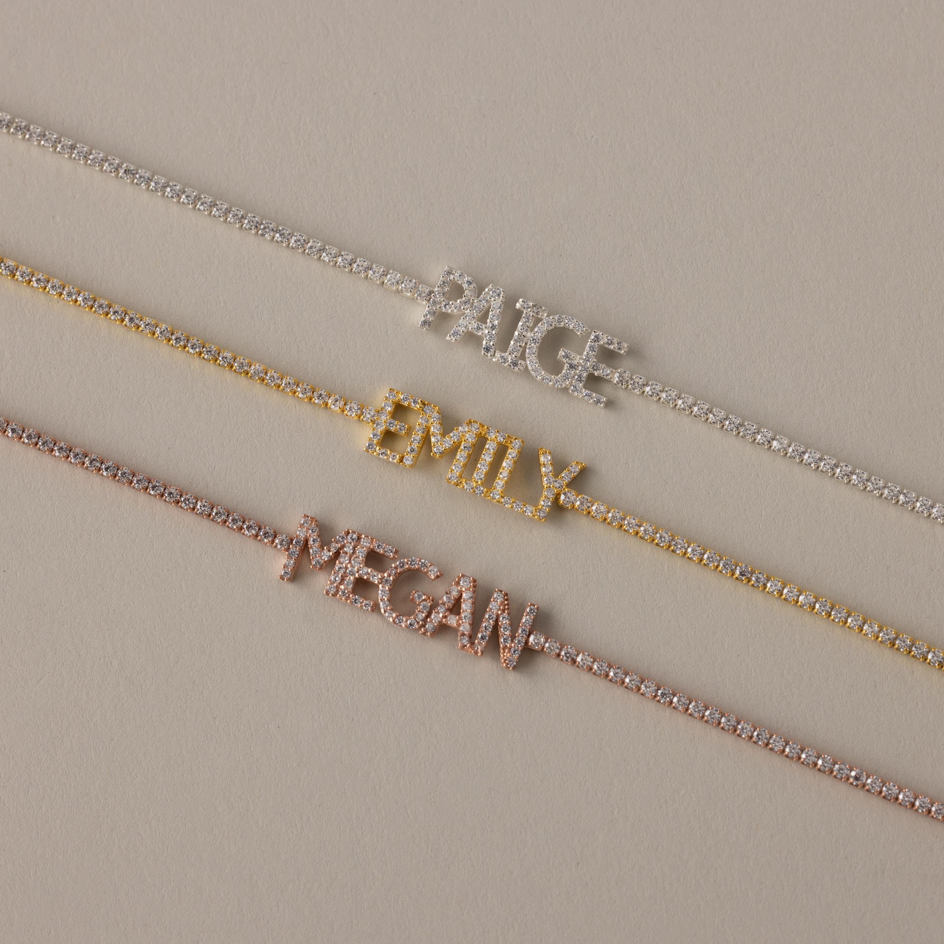 Three jeweled necklaces with the names Paige, Emily, and Megan in silver, gold, and rose gold look stunning when paired with a Pave Name Tennis Bracelet for a truly custom style.