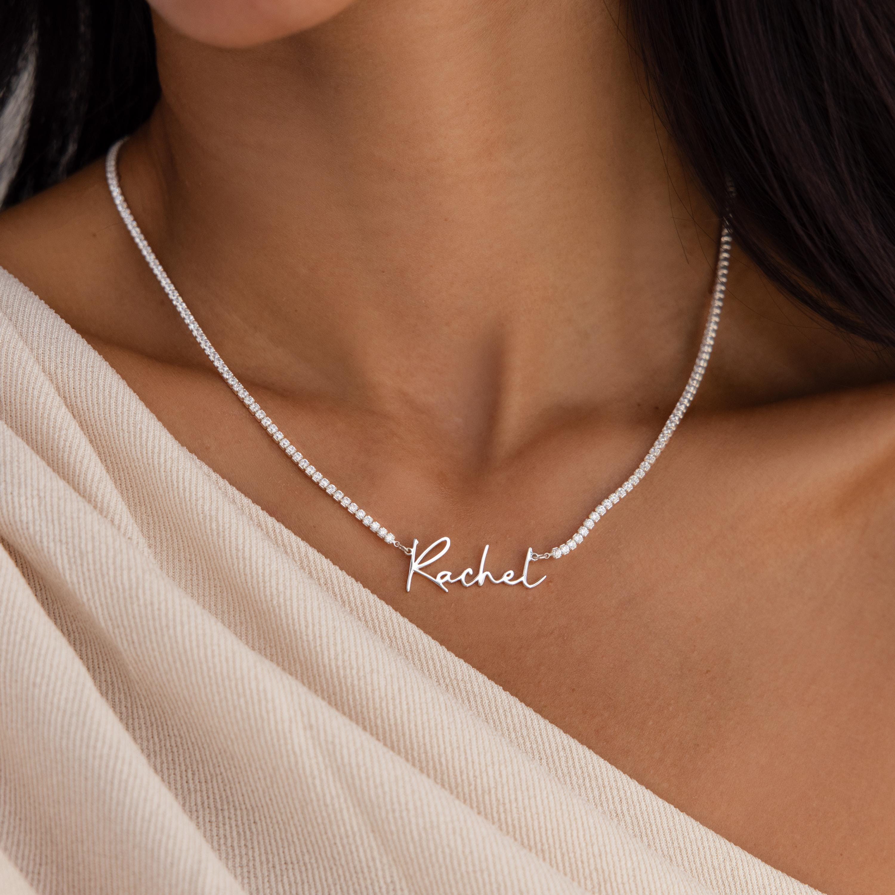 Close-up of a woman wearing the Diamond Tennis Name Necklace, featuring the name Rachel in cursive letters styled as a delicate tennis chain.