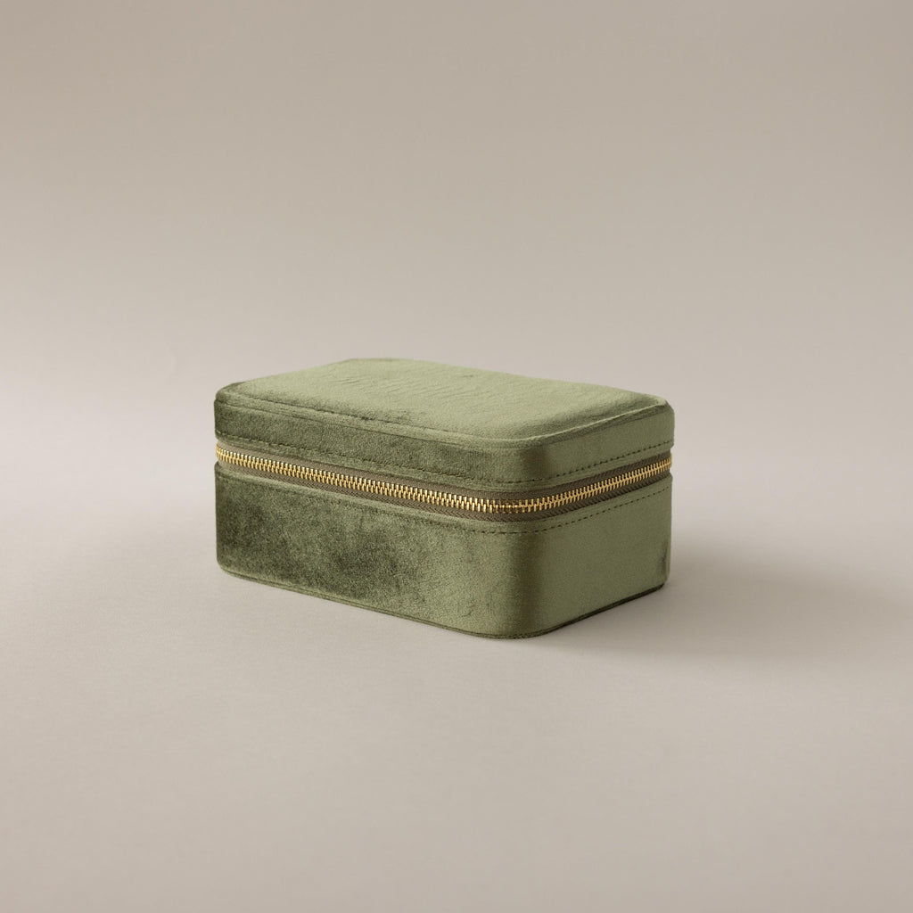 The Rectangle Velvet Jewelry Box in green velvet with a gold zipper is displayed on a plain light background.