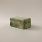 The Rectangle Velvet Jewelry Box in green velvet with a gold zipper is displayed on a plain light background.