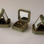 Three Velvet Mirror Jewelry Boxes, all green, shown with one open to display gold rings. Each box features a mirror inside the lid.