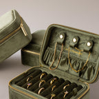 The Rectangle Velvet Jewelry Box, in green velvet, opens to neatly display and organize gold rings, necklaces, and bracelets.