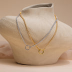 The Diamond Tennis Clasp Necklace in White Gold, ideal for weddings, is displayed on a textured beige jewelry bust.