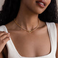 A woman wearing a white ribbed tank top and the Diamond Tennis Clasp Necklace, styled with delicate wedding jewelry.
