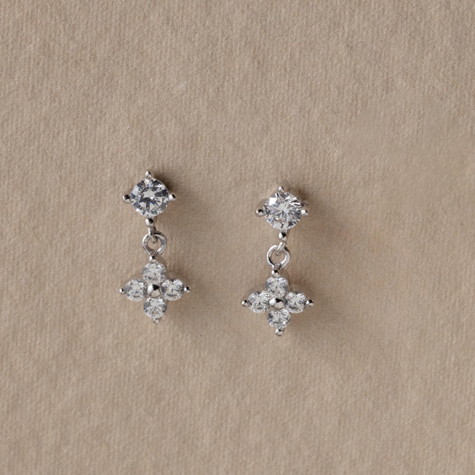 Ivy Flower Flat Back Studs in Sterling Silver, featuring round and flower-shaped diamond clusters on a beige background—an elegant Mother’s Day gift sure to impress.