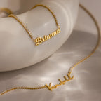 Two Diamond Tennis Name Necklaces, personalized with "Brianna" and "Kendall," are shown on a smooth surface—elegant custom pieces reflecting the latest nameplate jewelry trend.