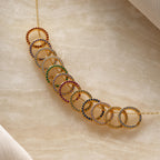 The Pave Pink Tourmaline Charm Clip, perfect for fans of personalized jewelry, is showcased on a light marble surface.