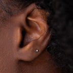 Dainty silver north star stud earring with tiny CZ diamond in center.