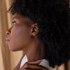Far view of silver Pave North Star Earrings on model's ear