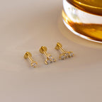 Flat lay of 3 dainty gold CZ Diamond Constellation Flat Back Stud Earrings, 2 earrings have heart shaped flat backs and 1 has classic circle back