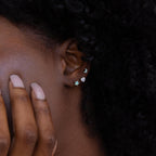 Close up of model wearing stacked set of 3 opal and diamond silver Celestial Stud Earrings with moon, heart, and star shapes