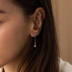 Model wearing silver Starburst Chain Stud Earrings.