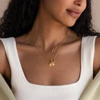 A woman, shown from shoulders to lips, wears a white ribbed tank top and a layered gold Cable Circle Charm Necklace.