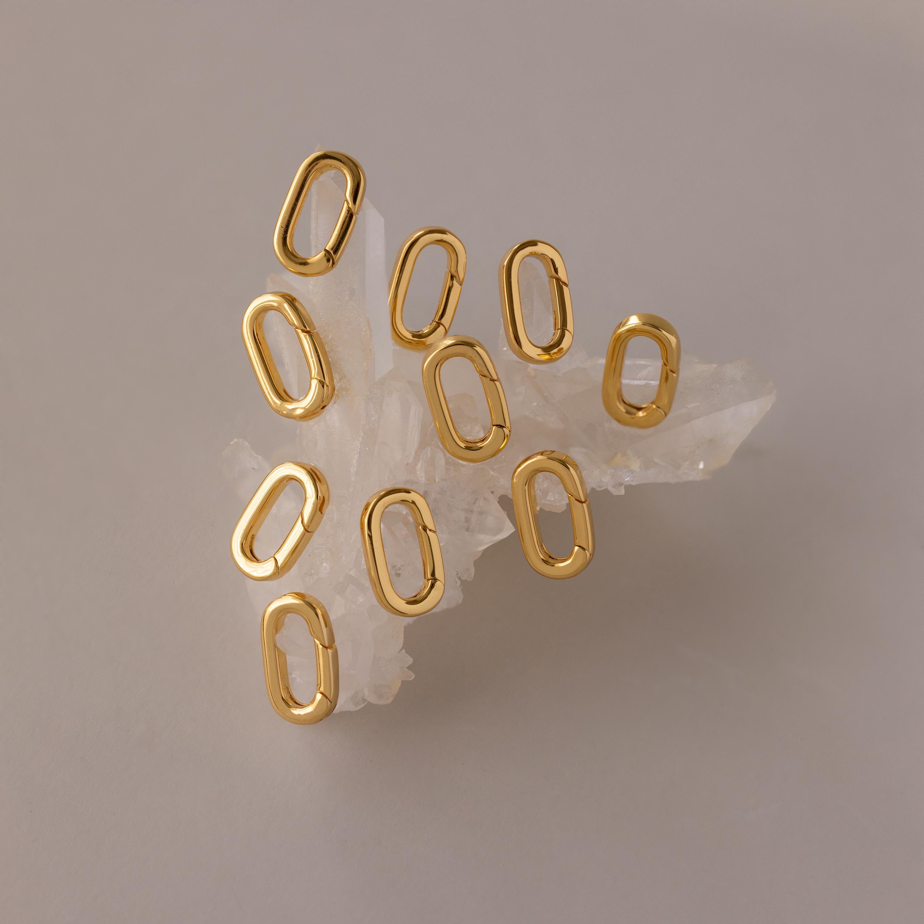 The Multipurpose Charm Hoop Clasp Set in 18K Gold features oval links on clear quartz, ideal for bracelet stacking or as a versatile connector in your jewelry designs.