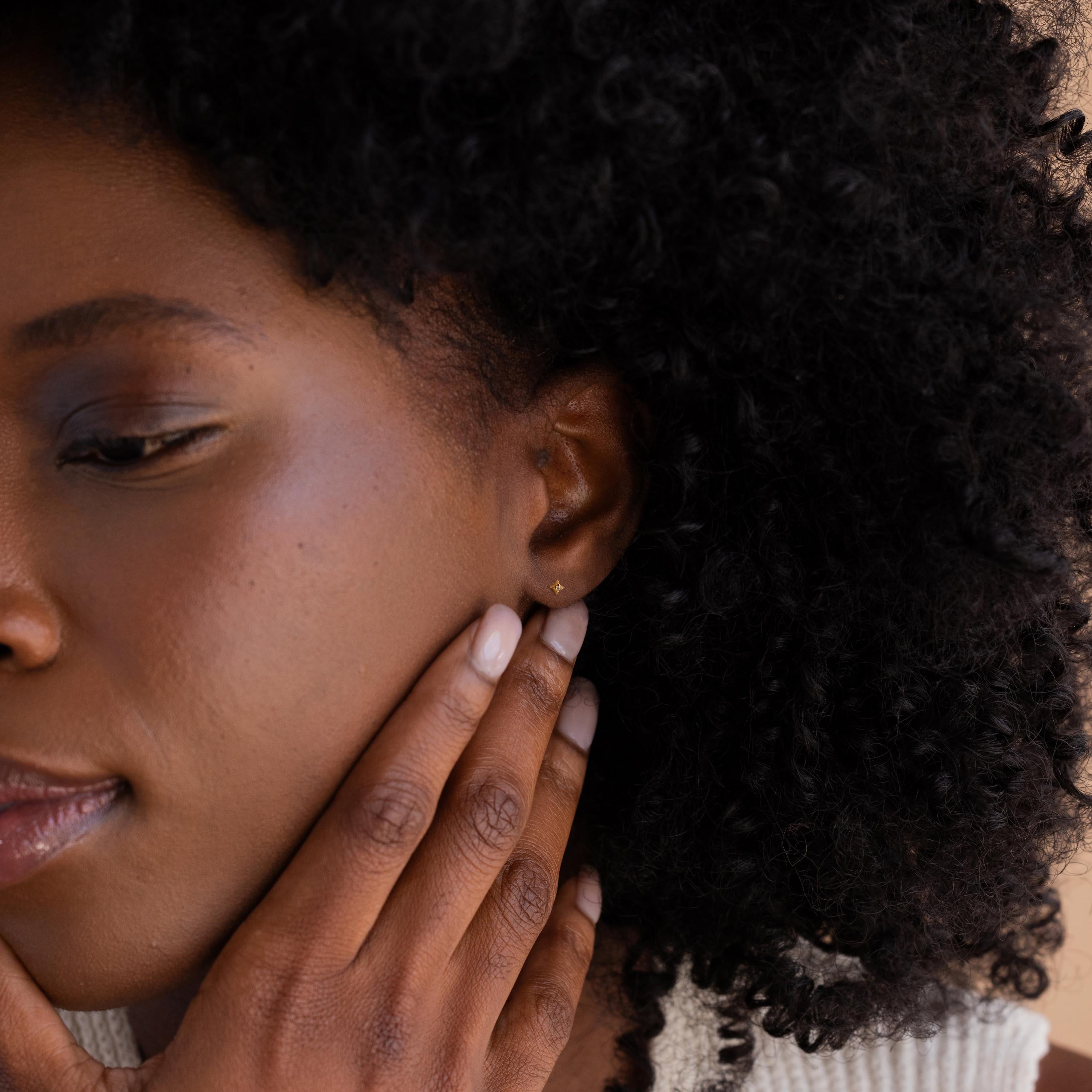 Model wearing gold  North Star Stud Earrings