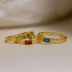 A blue zircon (December) Baguette Birthstone Curb Ring with a gold curb-link band, displayed on a neutral surface—a perfect choice for personalized jewelry or as part of a birthstone ring set.