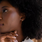 Medium shot photo of gold Pave North Star Earrings on model's ear