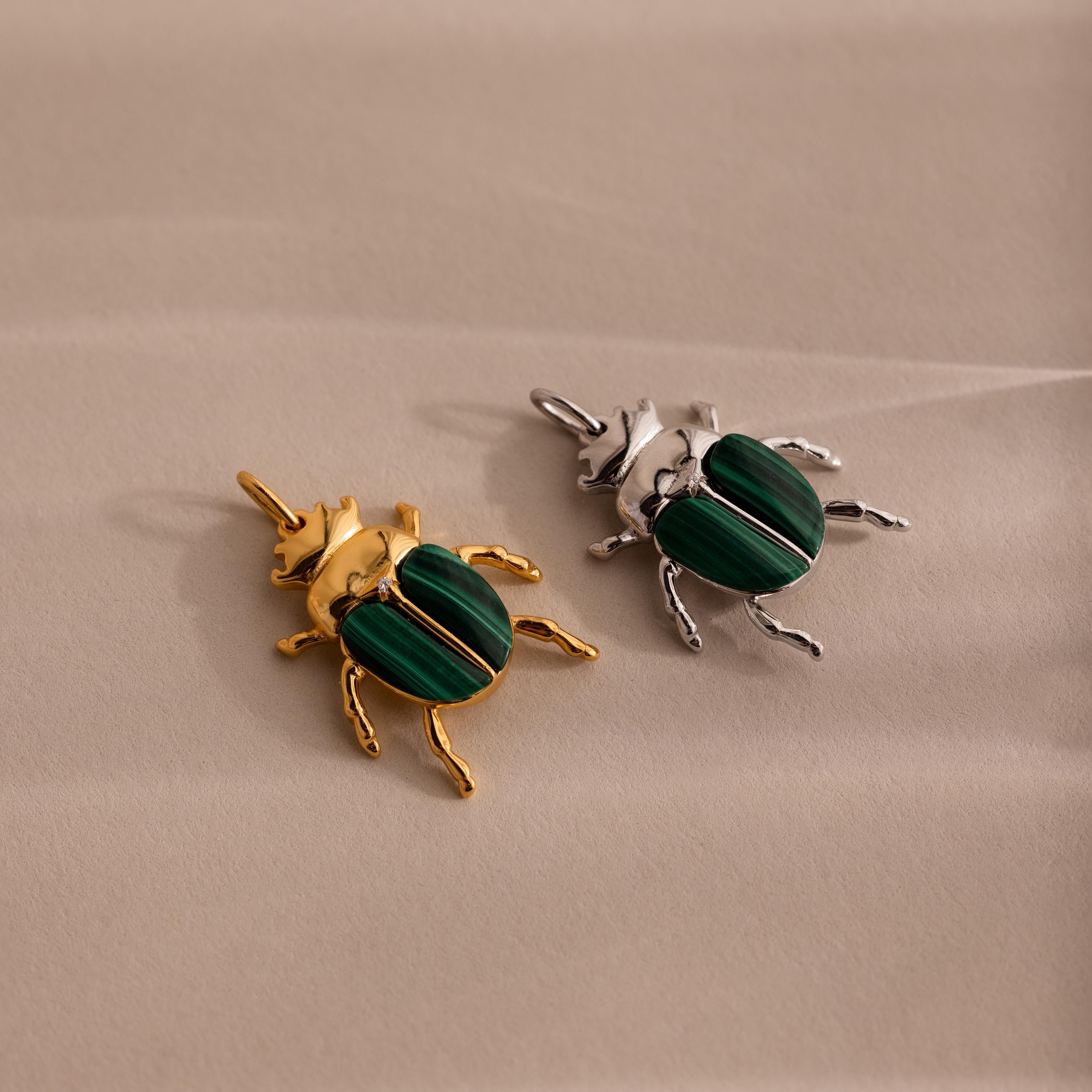 Two beetle charms side by side — one in gold and one in silver