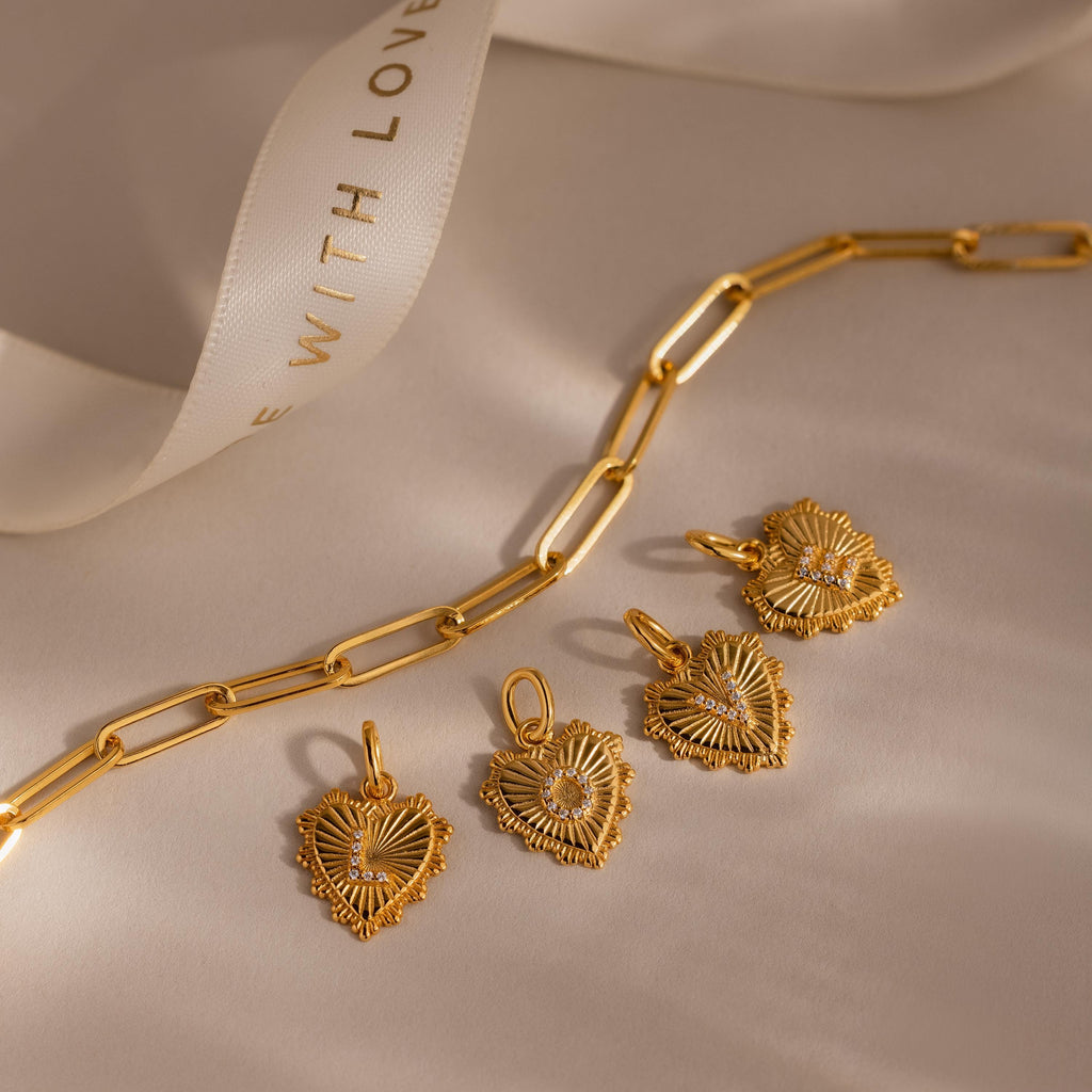 Initial Heart Pendants L O V E lay out besides a paperclip chain