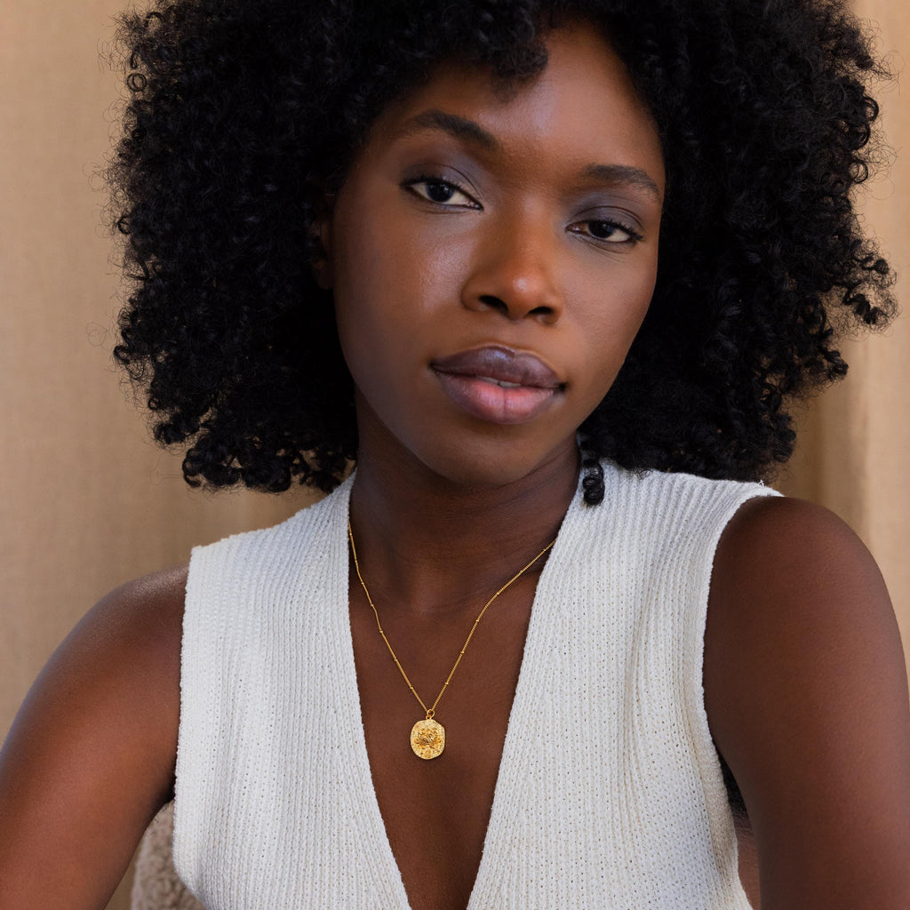Model wears a gold cancer Zodiac Gemstone Coin Necklace