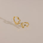 Close-up of the gold Pavé Viper Huggie Earrings