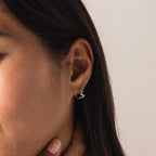 Model wearing a single Pavé Viper Huggie Earring in silver.