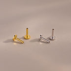 A set of four Flat Back Posts — two gold and two silver — arranged upright and angled on a neutral-toned background.