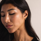 Model wearing the gold Pavé Viper Huggie Earring