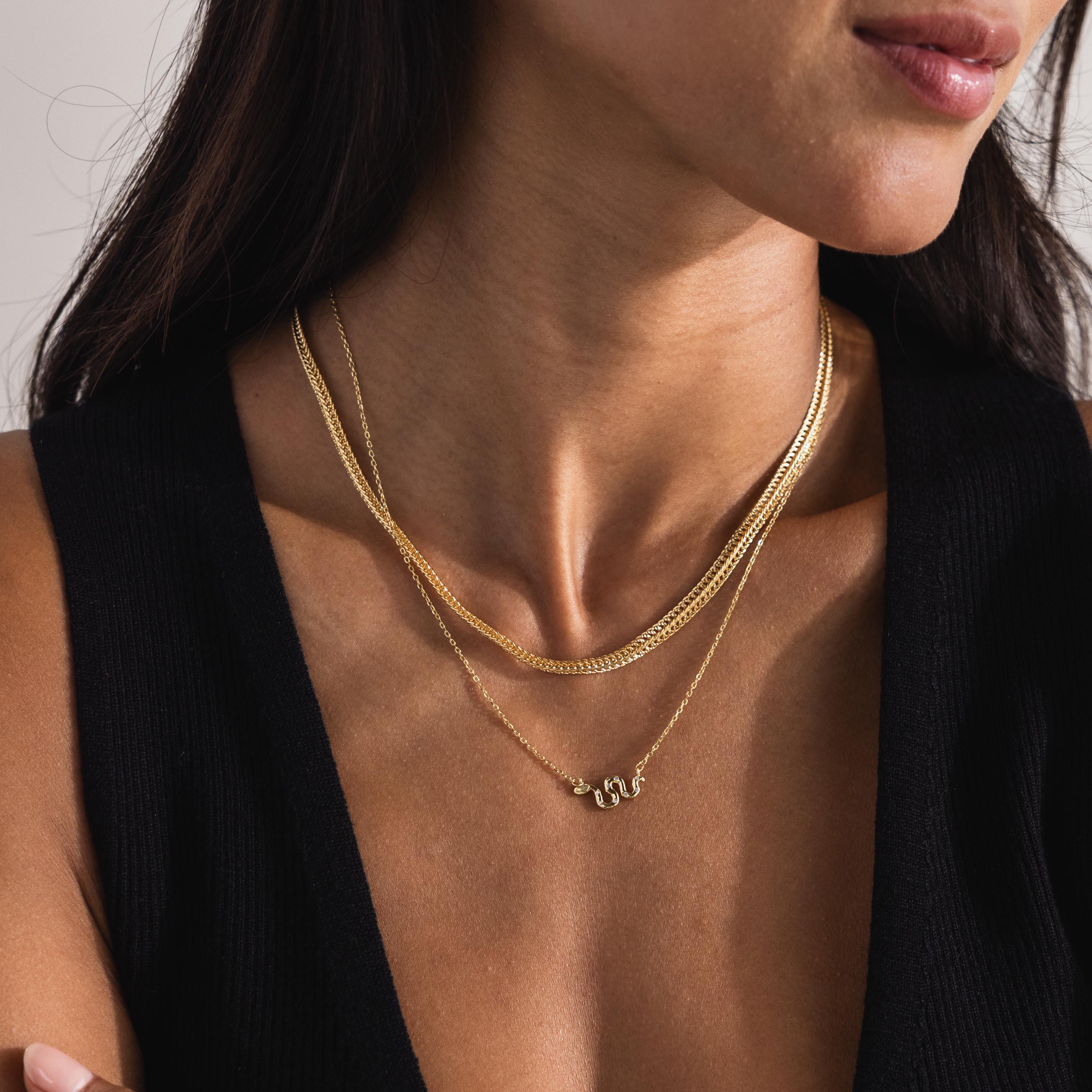Model layering the Thick Mesh Chain Necklace with a snake necklace