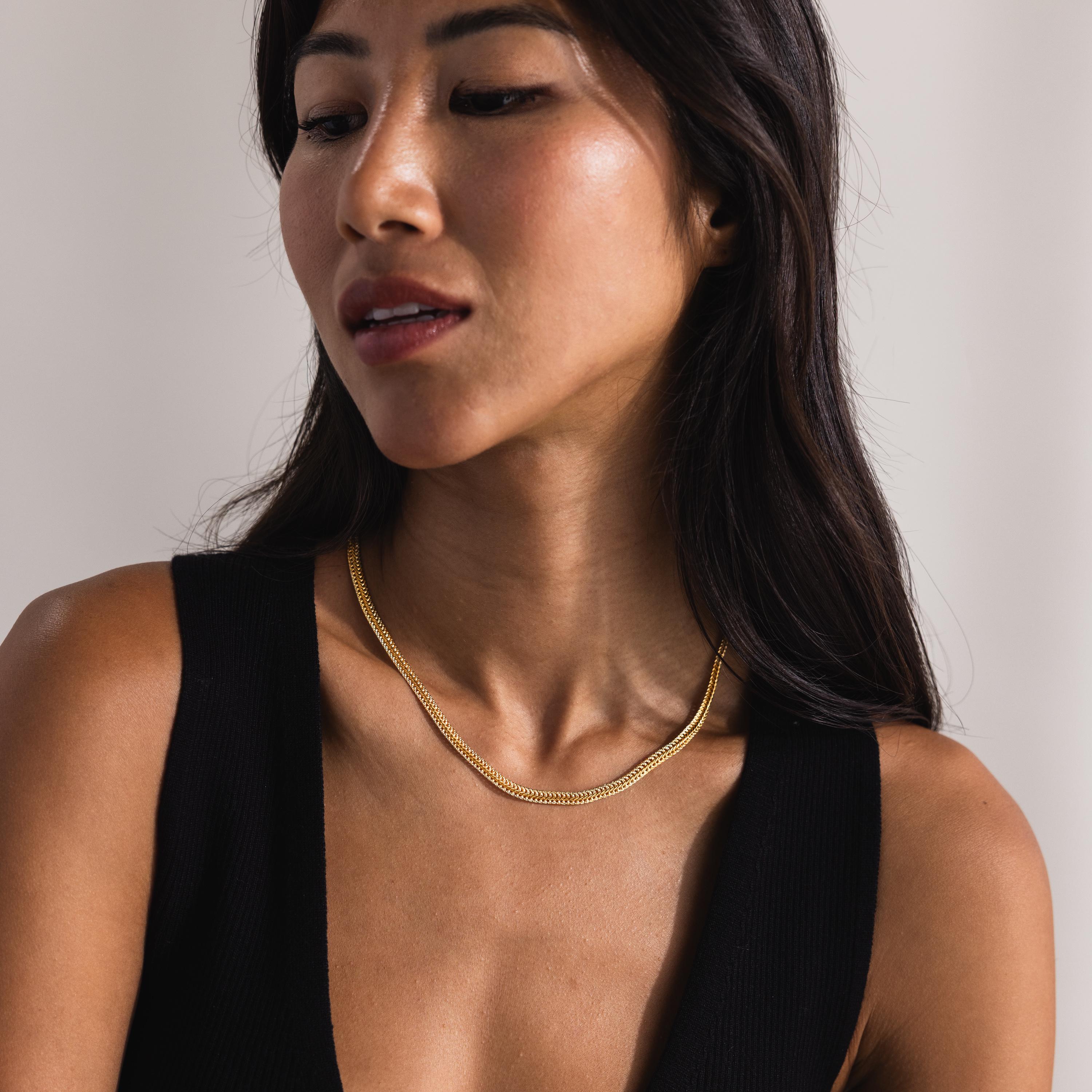 woman wearing the gold version of the Thick Mesh Chain Necklace