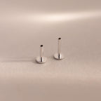 Two sterling silver Flat Back Posts standing upright side-by-side on a soft taupe backdrop.