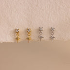 A side-by-side product display of all finish options: two pairs of 18k gold earrings and two pairs in sterling silver, lined up evenly on a softly textured white surface.