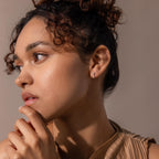 Model wears silver diamond star fatback earring and faces to the side