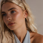 Model with multiple gold opal diamond earrings stacked along her earlobe, including the Opal Diamond Flat Back Earrings