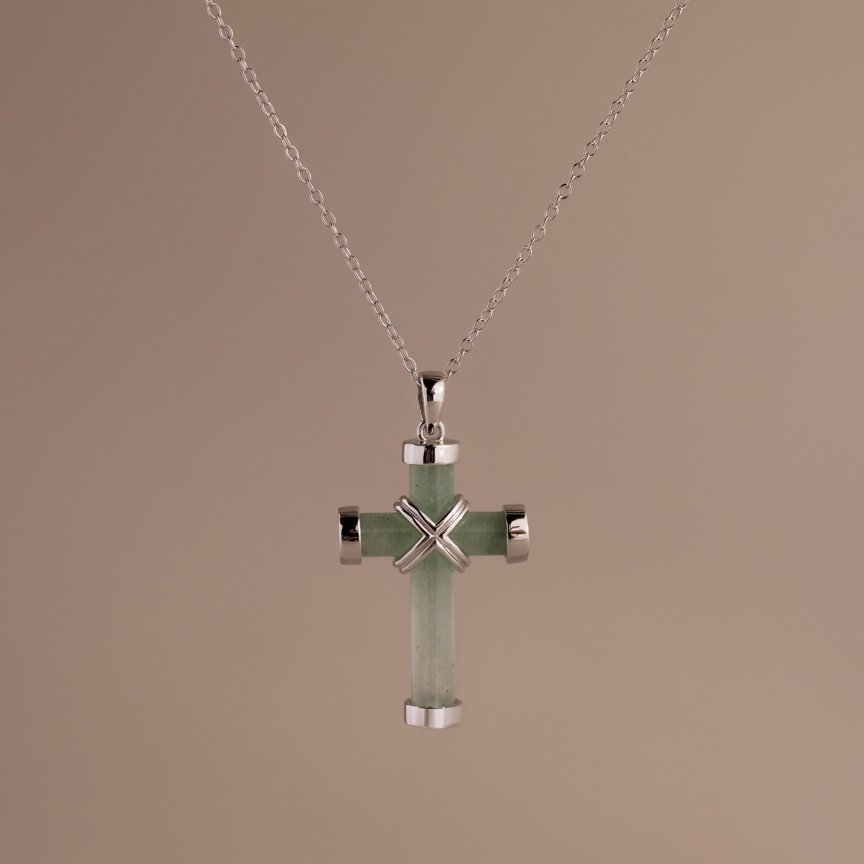Silver chain necklace with a jade cross pendant, featuring polished silver end caps and an X-shaped detail at the center.