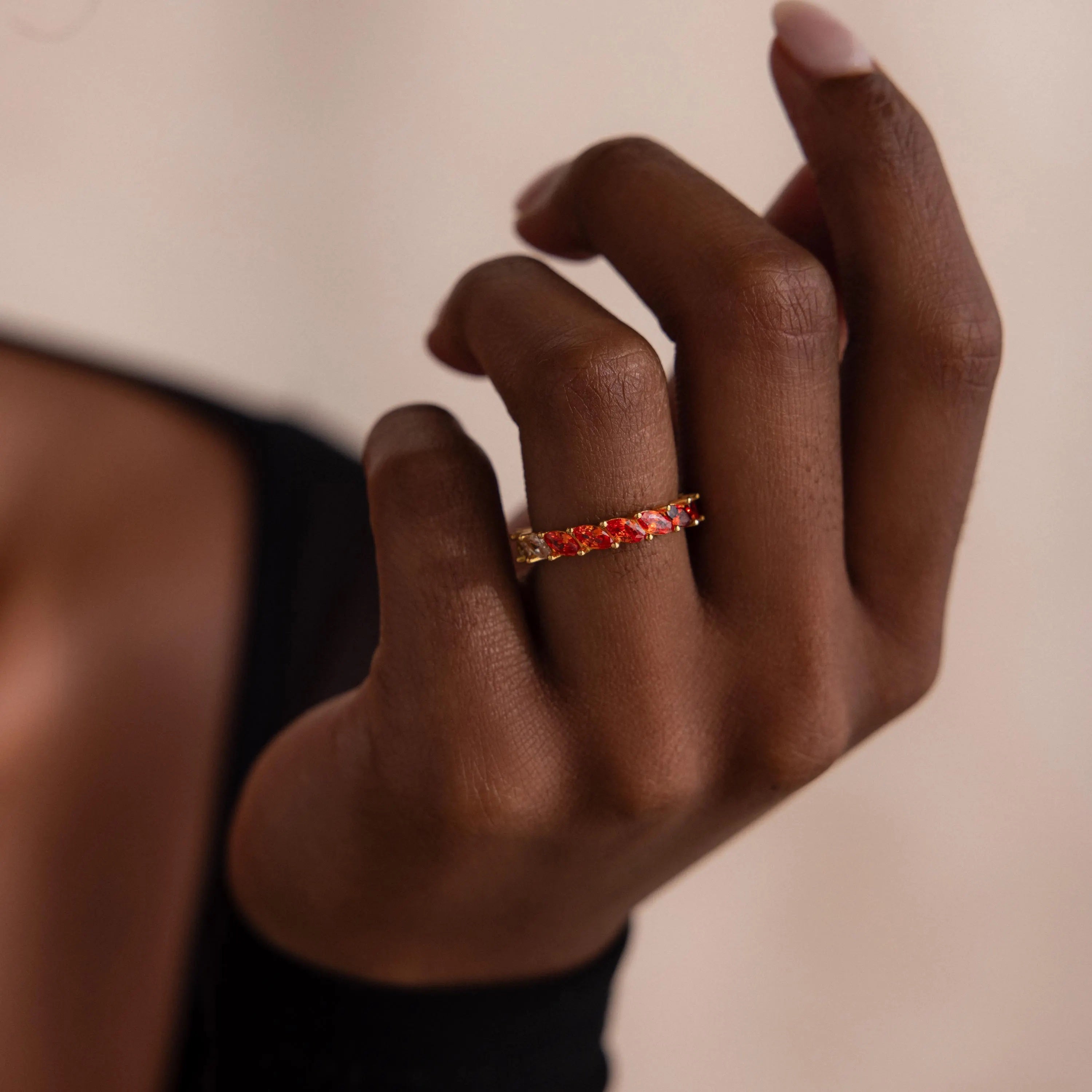 Model wearing a Red Marquise Ombre Ring with gradient marquise-cut stones in gold setting.
