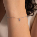 Delicate silver chain bracelet with a small crystal cross charm, minimalist and elegant jewelry piece that adds a subtle sparkle and meaningful touch to everyday style.