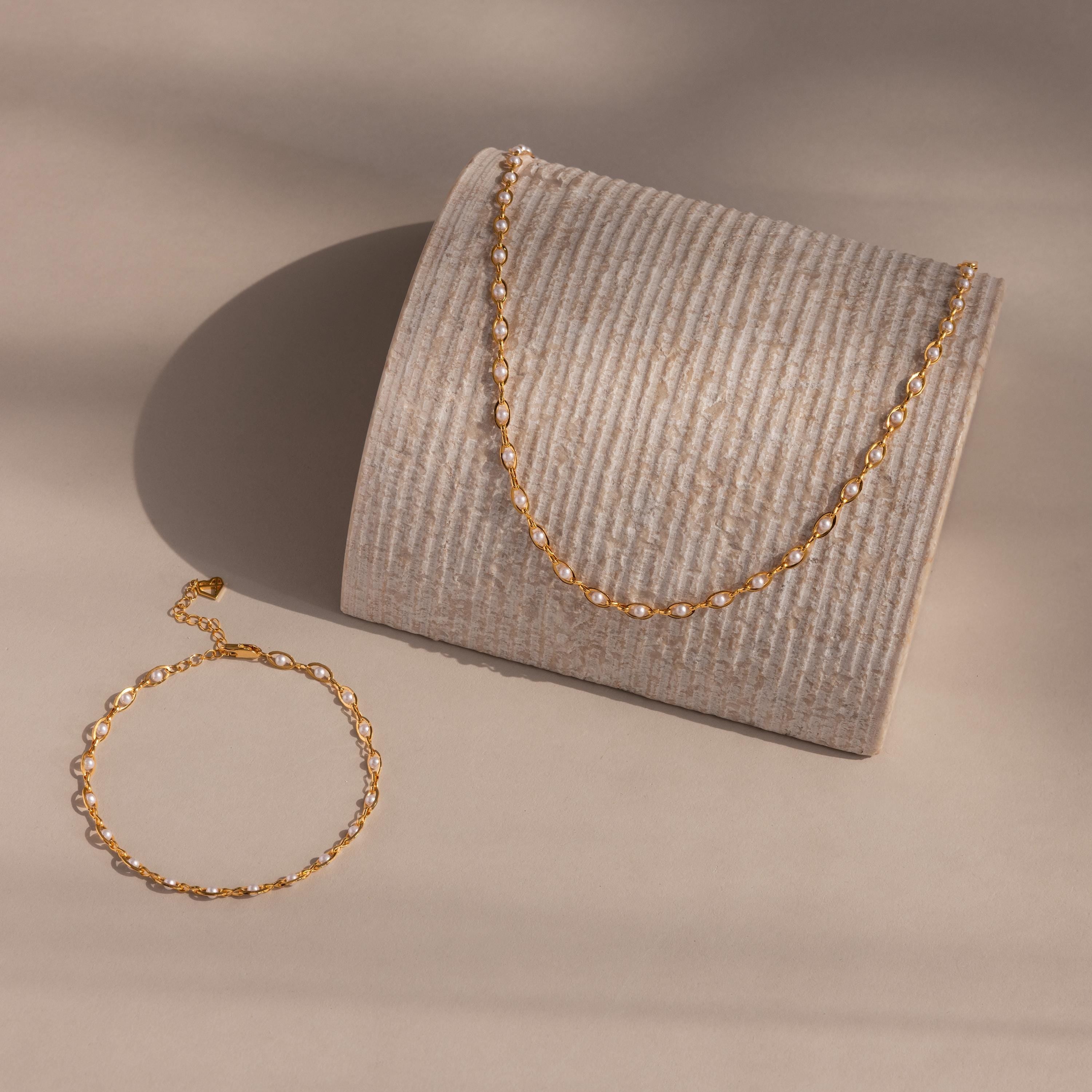 Eternity Pearl Choker Necklace and matching bracelet in gold, featuring a continuous row of Linked pearls for a timeless and elegant look.