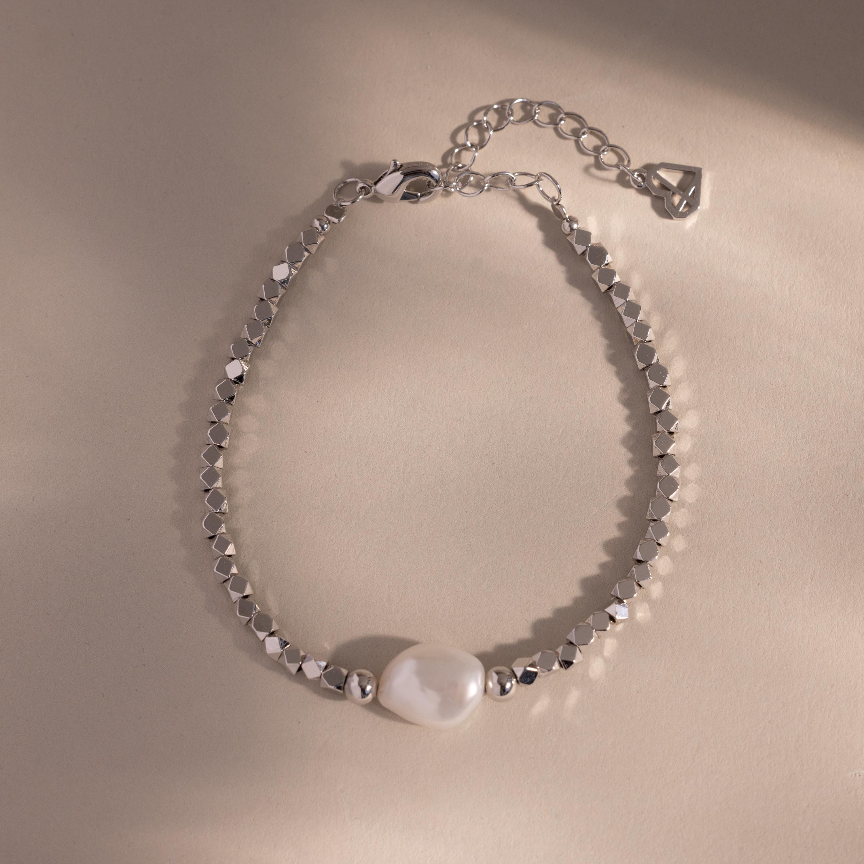 Beaded Pearl Bracelet in silver featuring faceted metallic beads with a single natural white pearl centerpiece, displayed on a neutral background for a sleek, modern look.